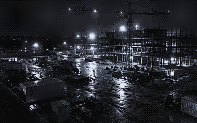 Night camera view of a construction site with a tower crane