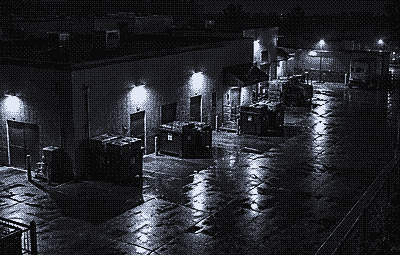Night camera view of the back door and bins behind a restaurant
