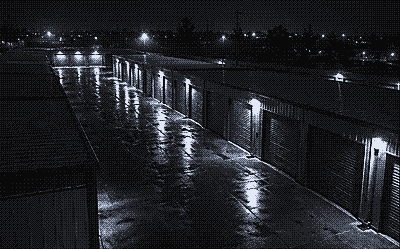 Night camera view of a self storage aisle with roll up doors